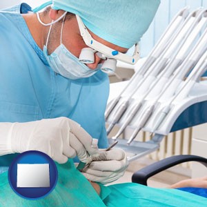 an oral surgeon operating on a dental patient - with Colorado icon